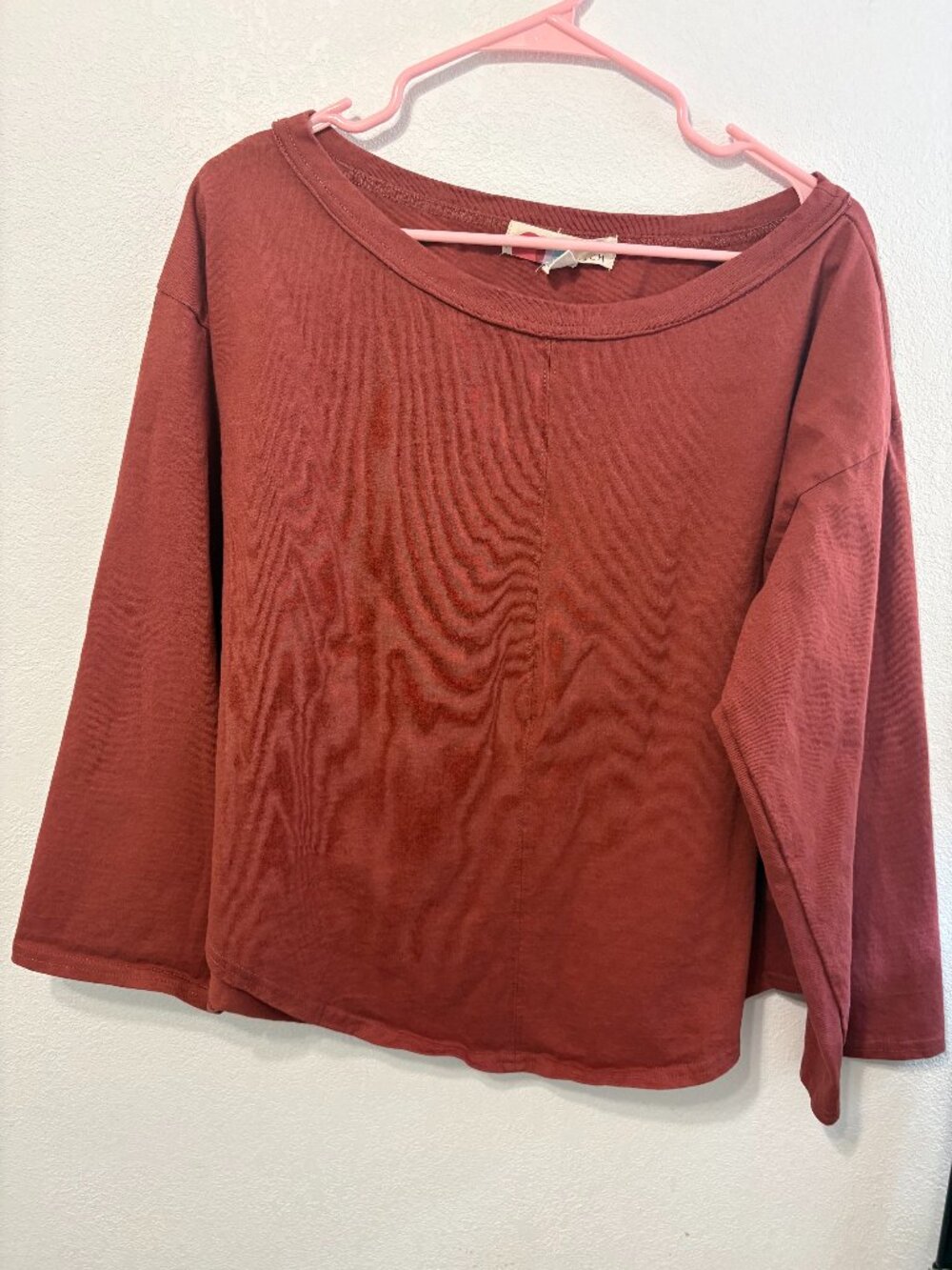 Free People "Beach" sub-brand top in a terracotta/rust color